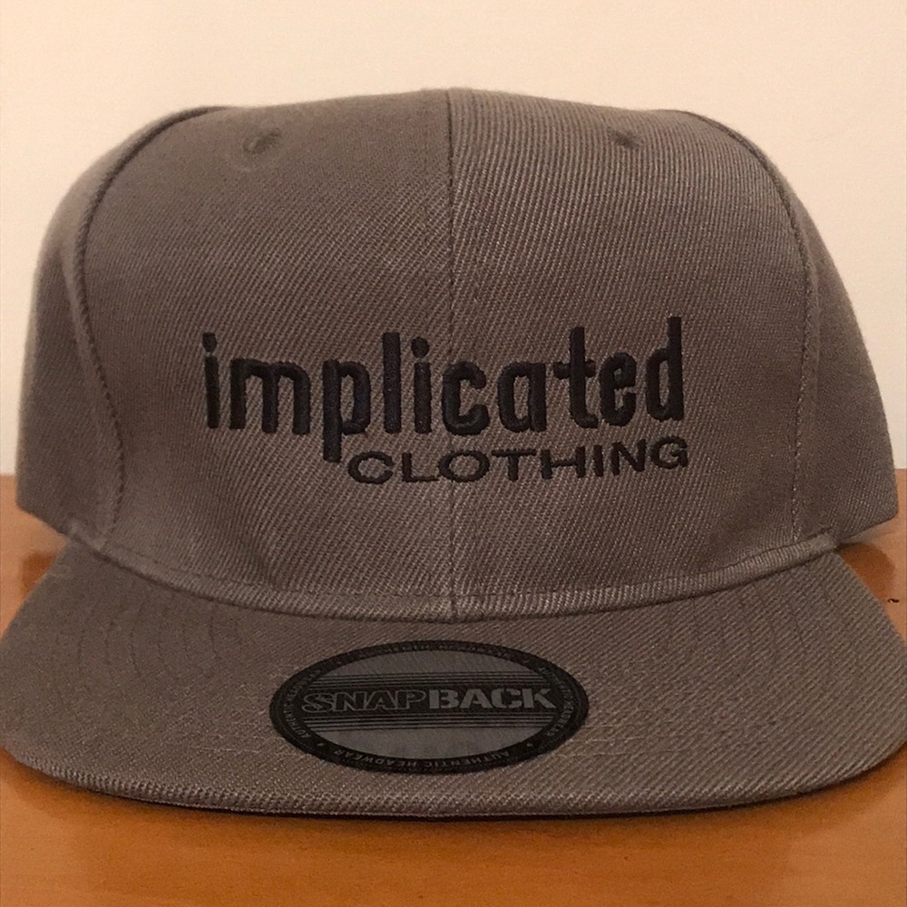Dark Grey “Implicated Clothing” Snap back hat